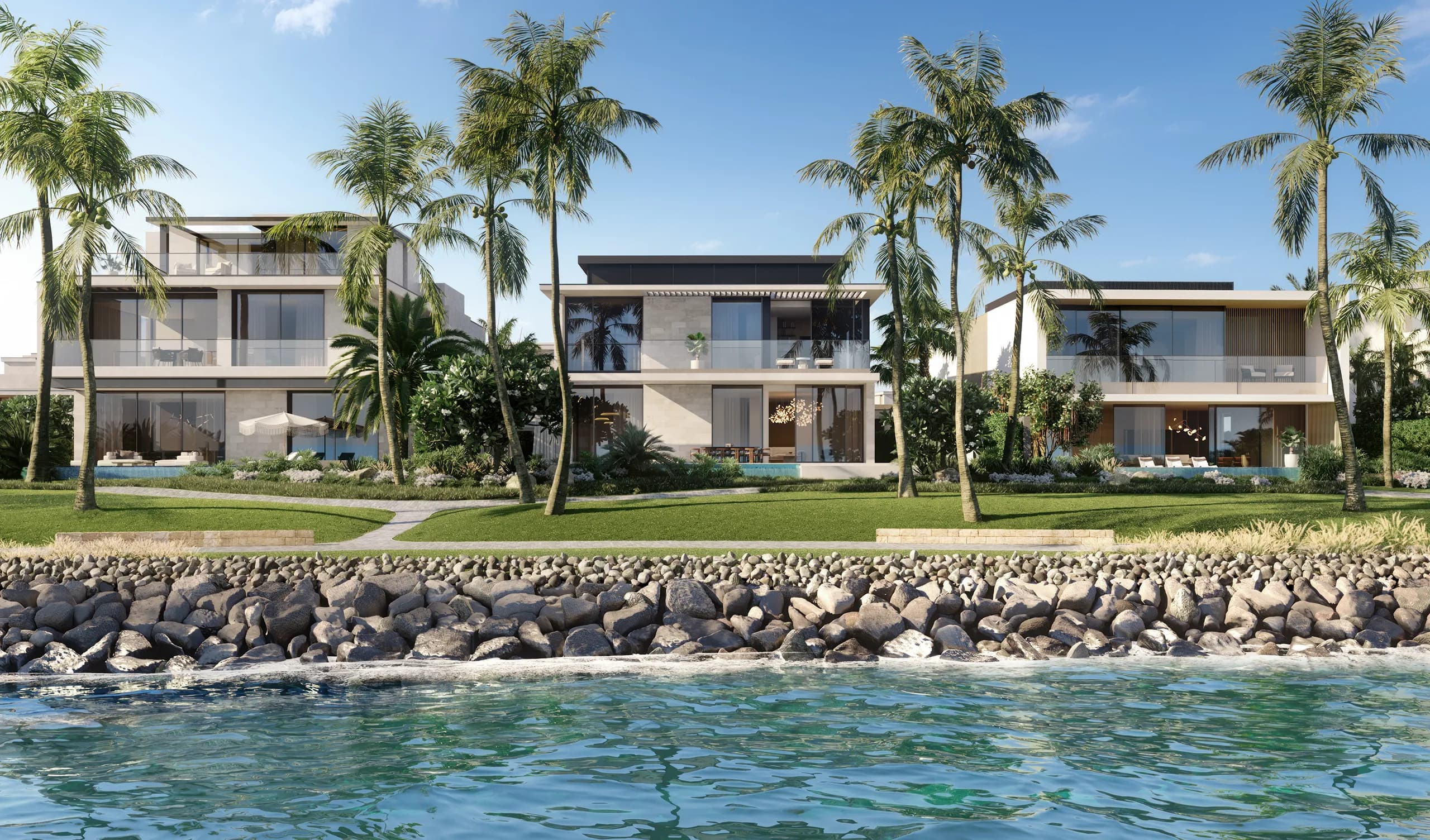 Sheltered waterfront and shoreline park between Bay Villas residences on Dubai Islands, with calm lagoon-style water beside the homes